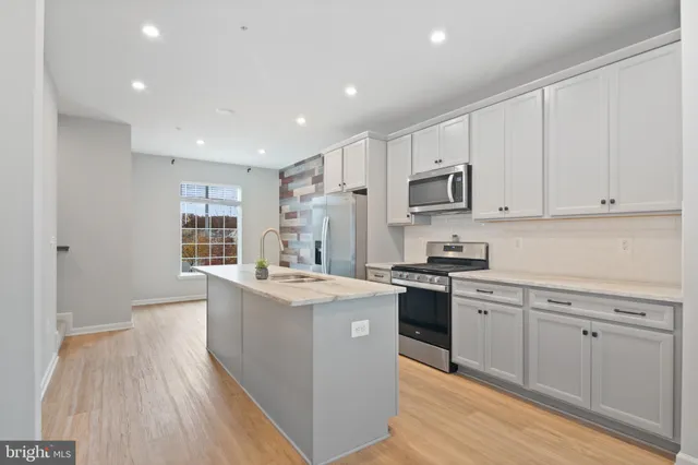 a kitchen with stainless steel appliances granite countertop a stove and a sink