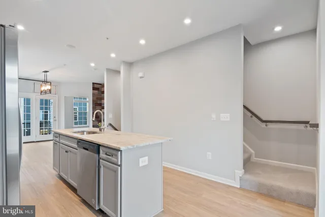 a large kitchen with a sink and large window