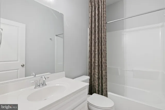 a view of a hallway with washer and dryer