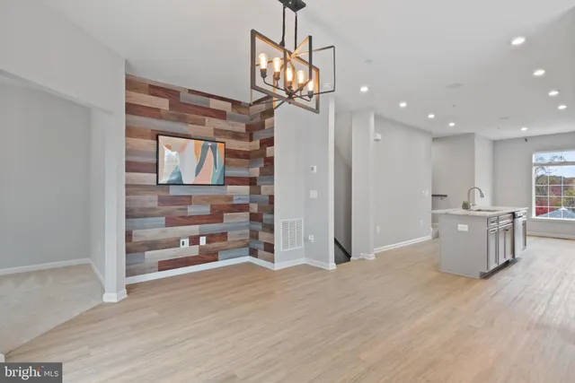 a view of a kitchen with furniture and wooden floor