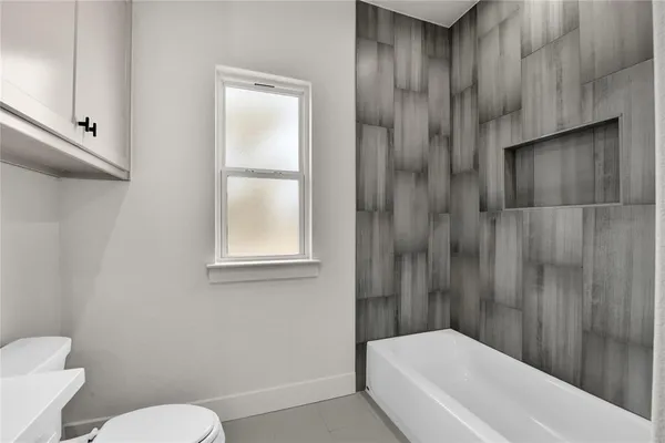 a bathroom with a toilet and a bathtub