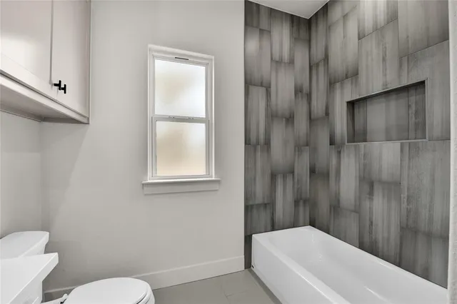 a bathroom with a toilet and a bathtub