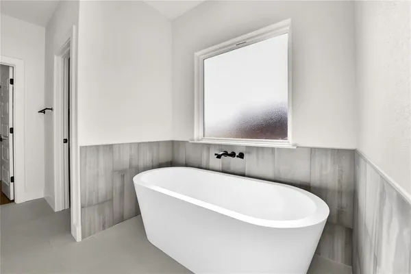 a white bath tub sitting in a bathroom