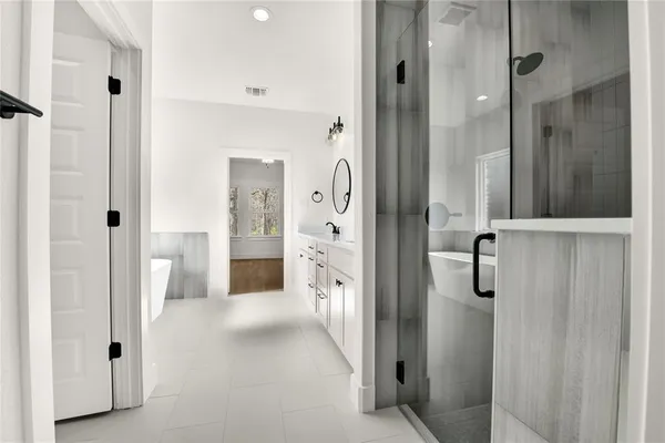 a bathroom with a shower and a mirror