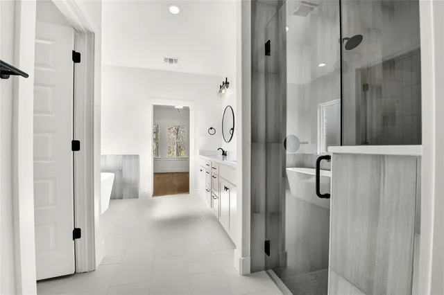 a bathroom with a shower and a mirror