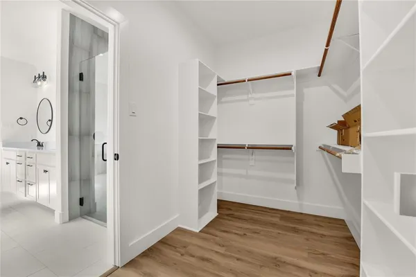 a view of walk in closet with empty racks