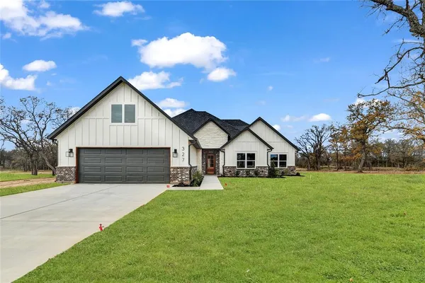 a front view of house with yard and green space