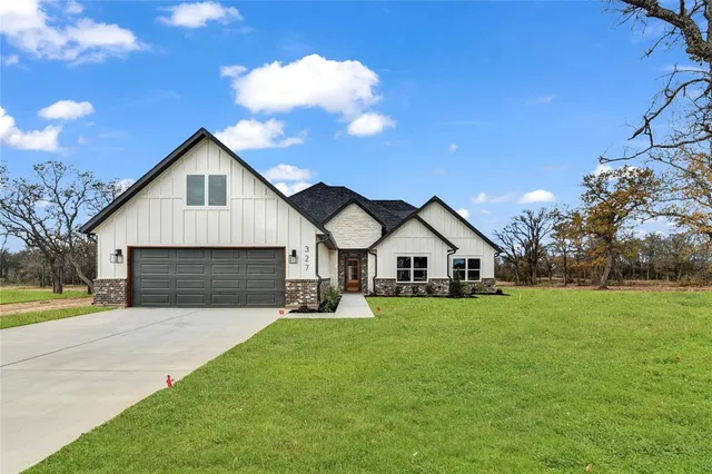 a front view of house with yard and green space