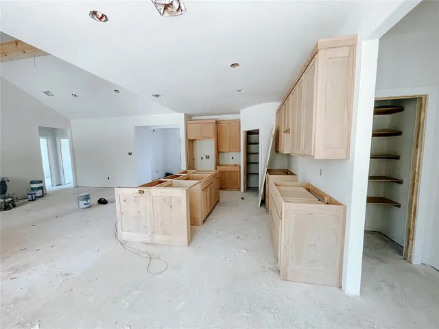 a view of kitchen with stainless steel appliances cabinets