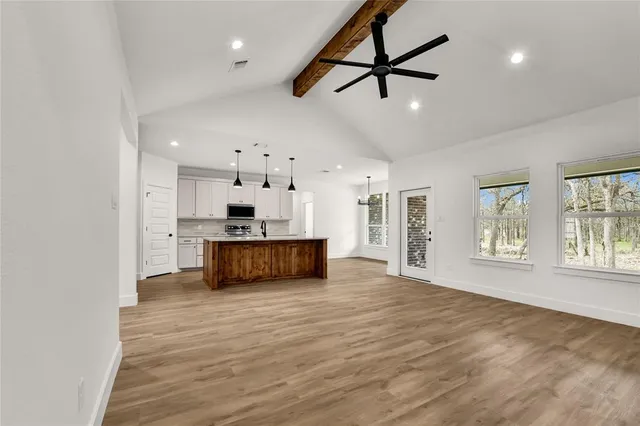 a view of kitchen with stove and cabinets