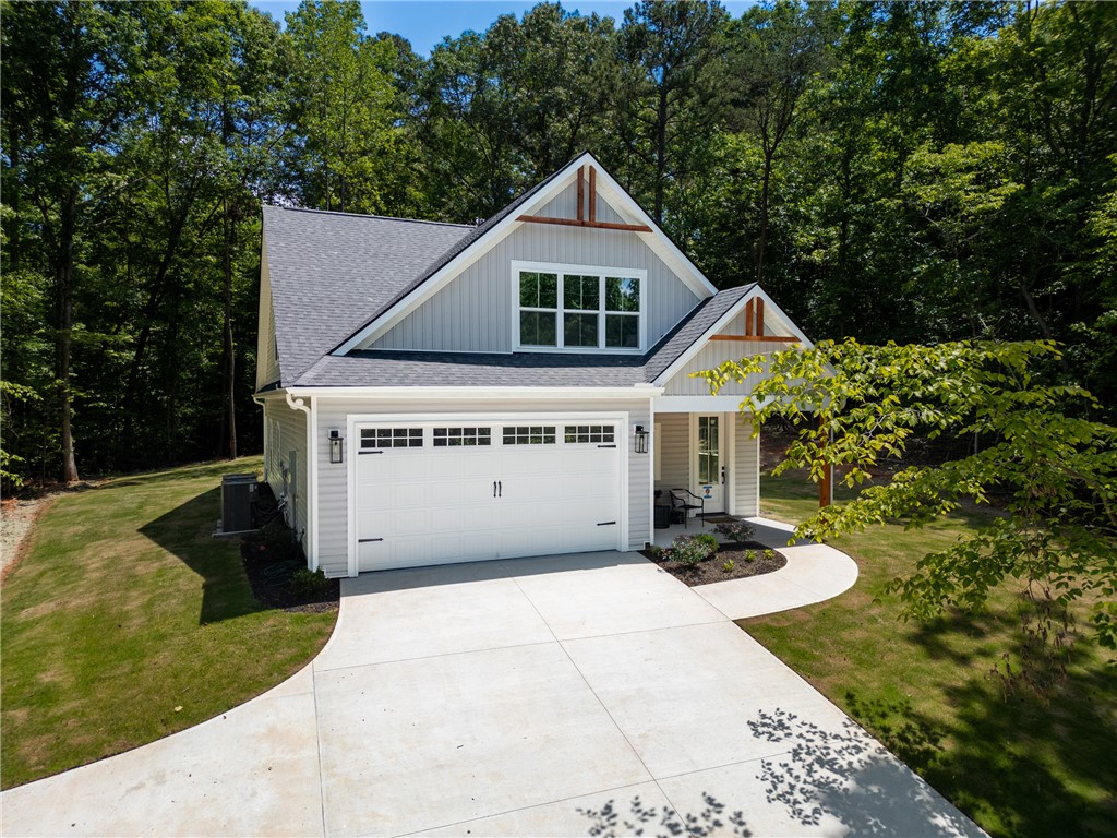 502 Point Road Westminster, SC 29693 - Photo 1 of 49 A welcoming facade showcases a broad driveway leading to a garage and an inviting front entrance.