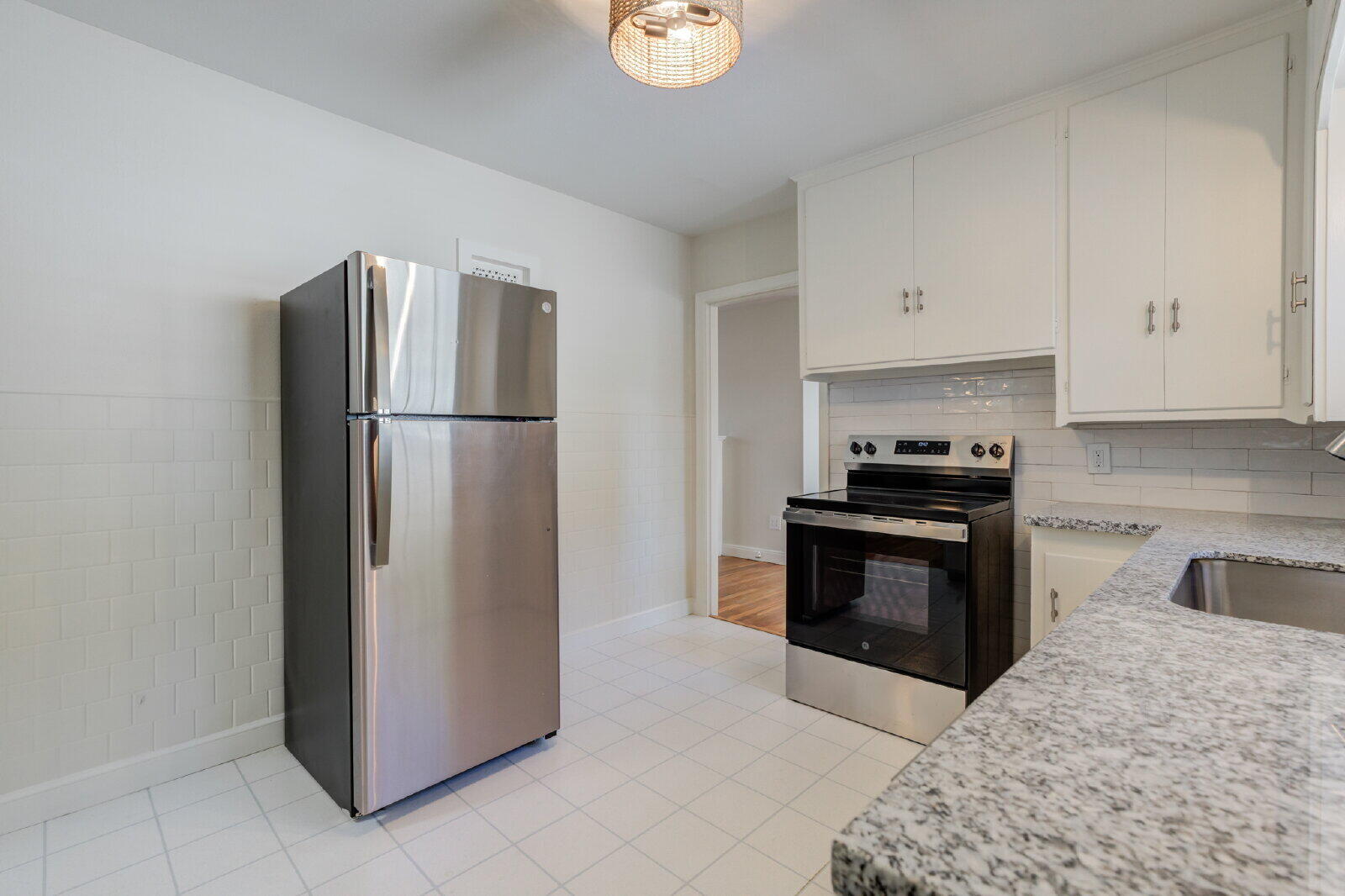 2710 27th Street Lubbock, TX 79410 - Photo 19 of 38 a kitchen with a refrigerator and a stove top oven