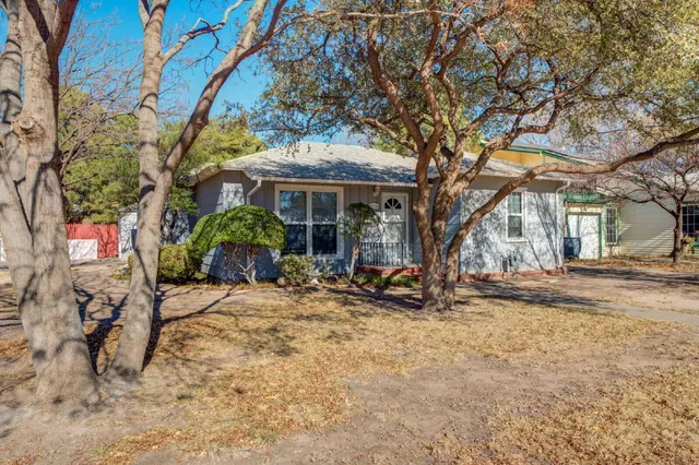 a view of a house with a tree in the background