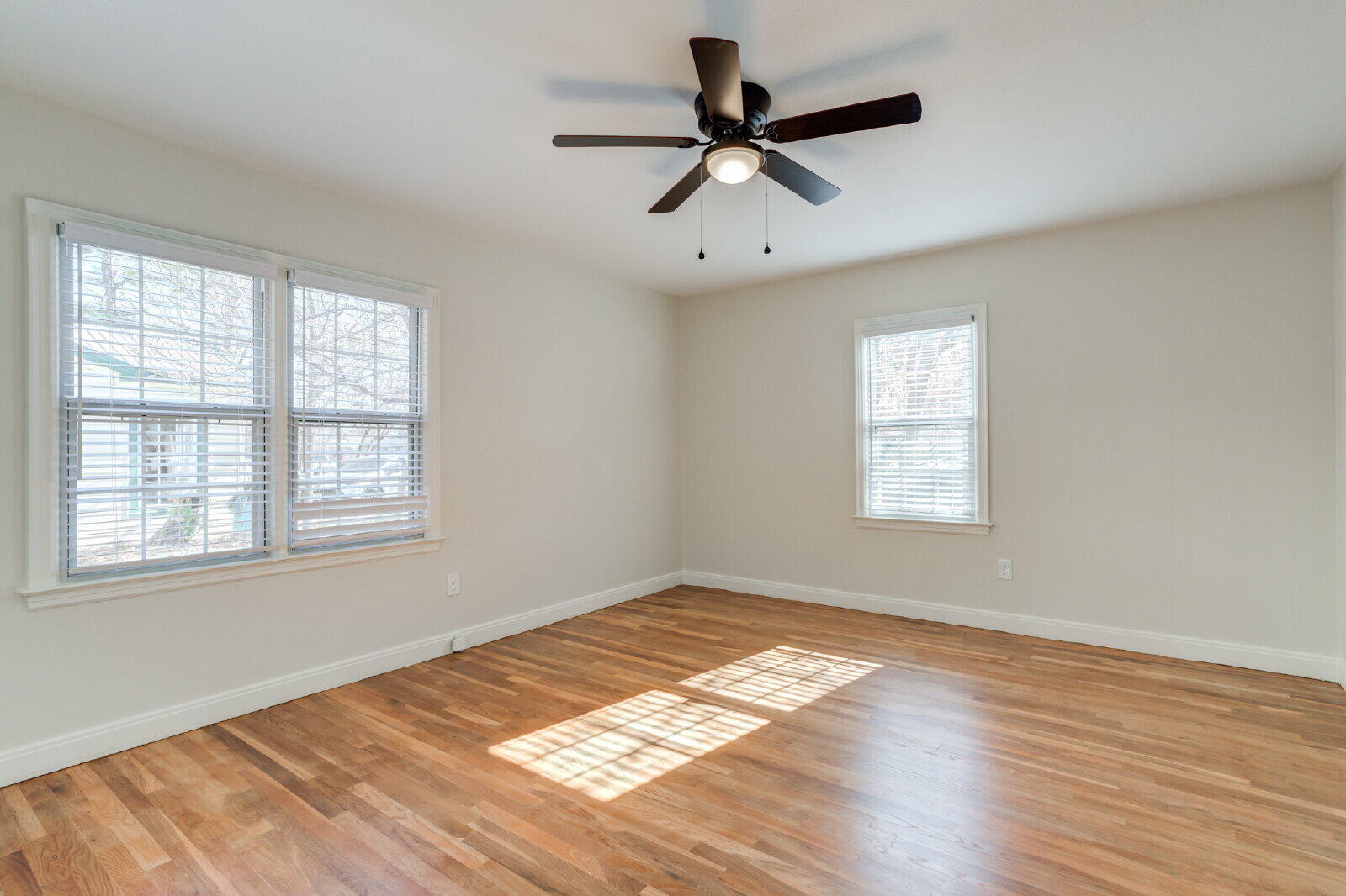 2710 27th Street Lubbock, TX 79410 - Photo 21 of 38 a view of a big room with wooden floor and windows