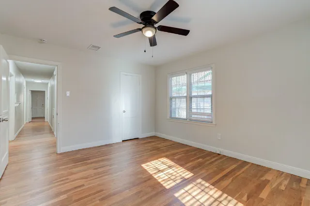 wooden floor in an empty room with a window