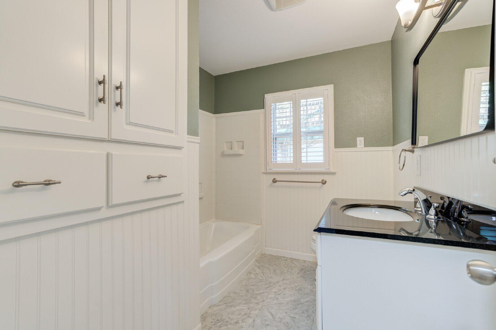 2710 27th Street Lubbock, TX 79410 - Photo 23 of 38 a bathroom with sink bathtub and window