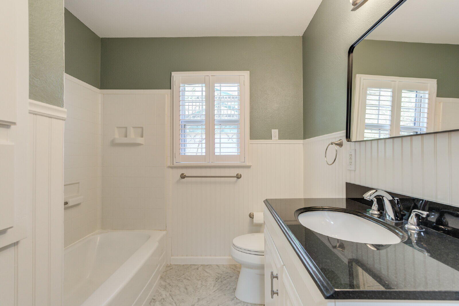 2710 27th Street Lubbock, TX 79410 - Photo 24 of 38 a bathroom with a sink toilet a tub and shower