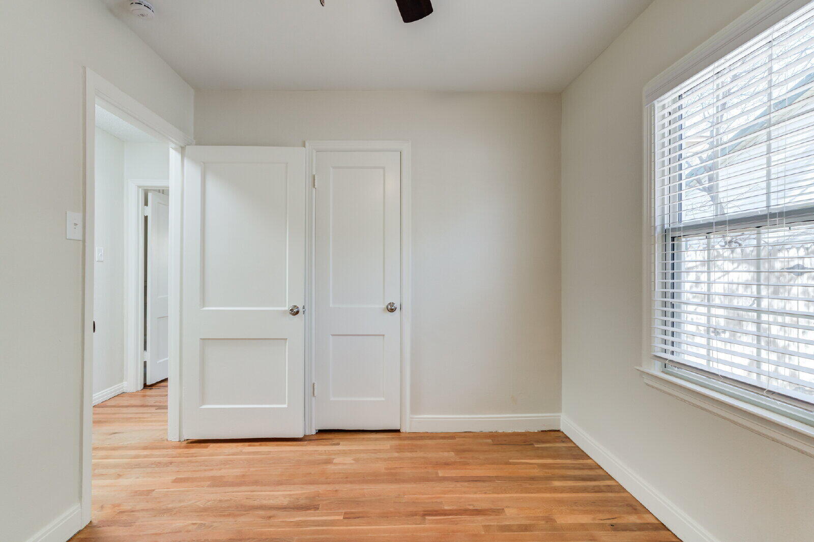 2710 27th Street Lubbock, TX 79410 - Photo 27 of 38 a view of an empty room with wooden floor and a window