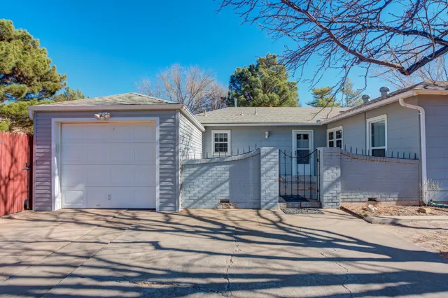 a view of a house with a patio and a yard