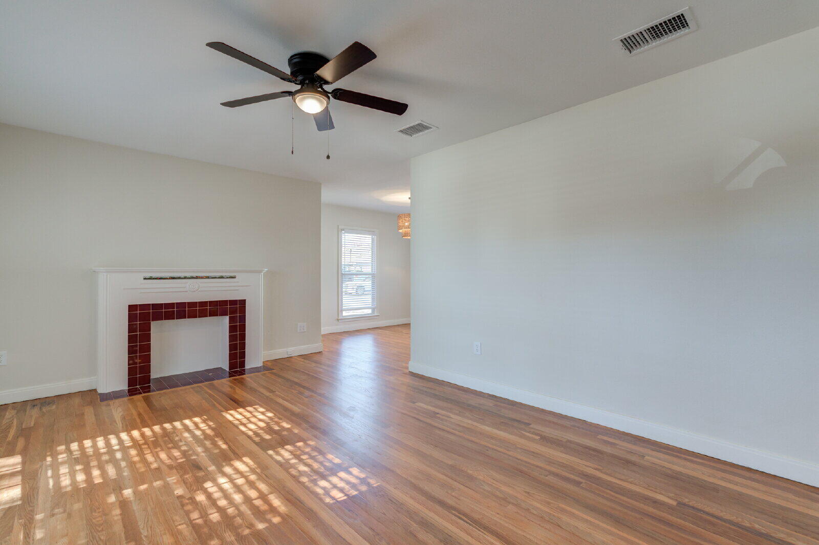 2710 27th Street Lubbock, TX 79410 - Photo 6 of 38 wooden floor in an empty room with a window
