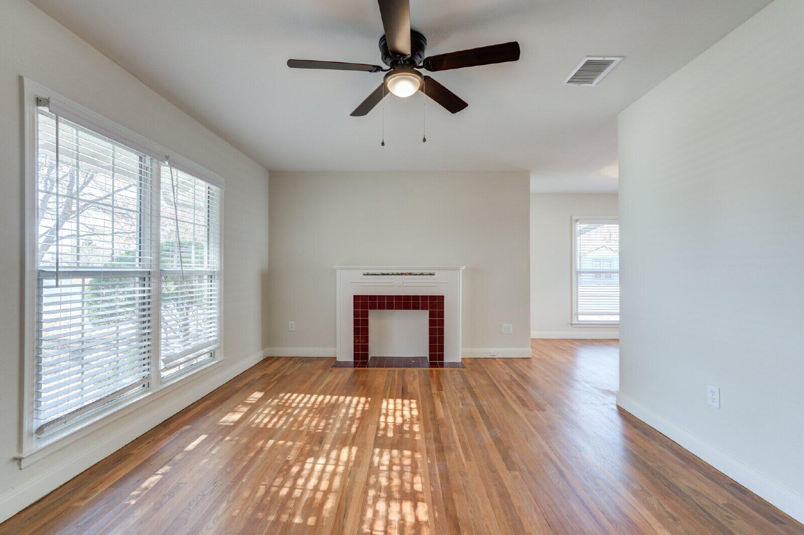 2710 27th Street Lubbock, TX 79410 - Photo 7 of 38 a view of empty room with wooden floor and fan