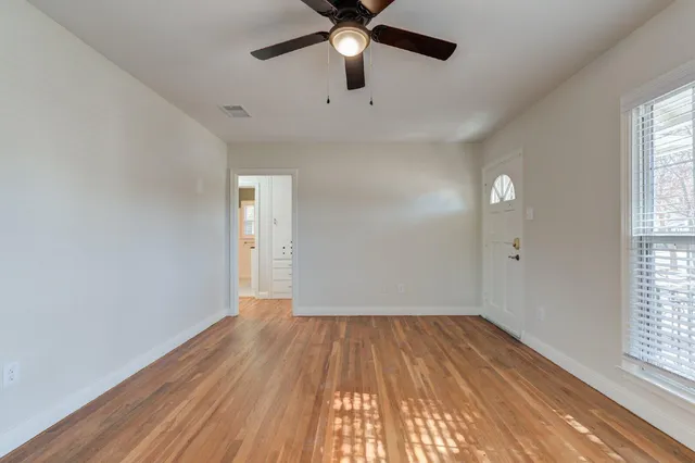 wooden floor in an empty room with a window