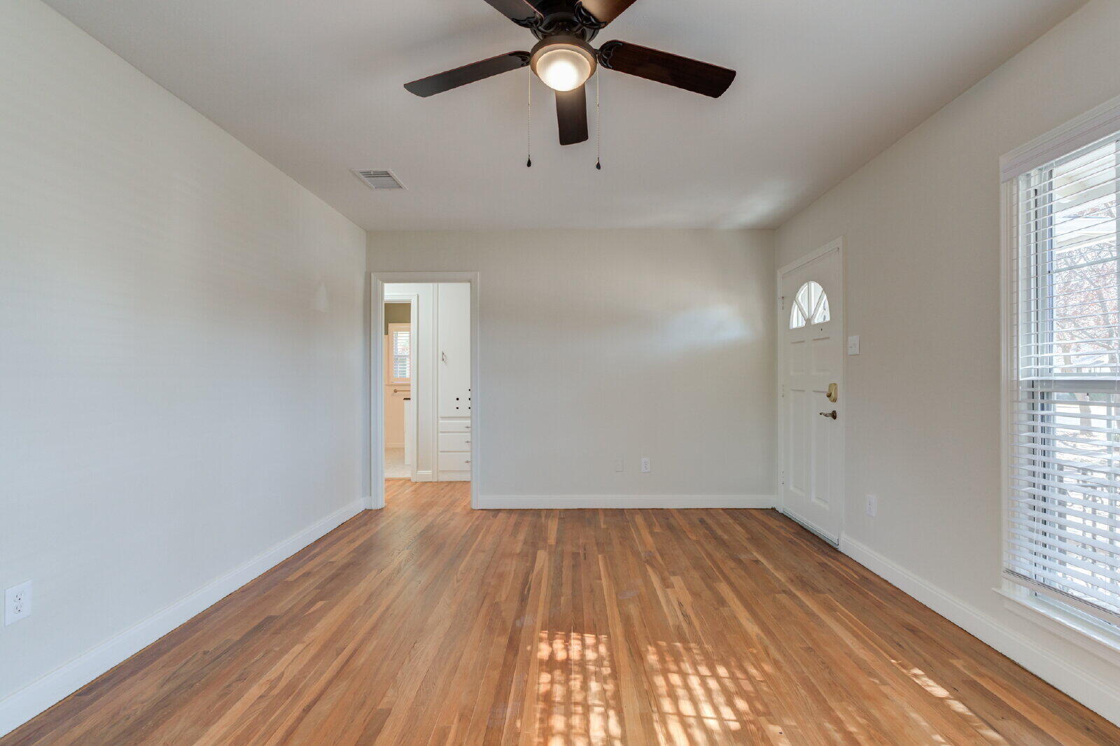 2710 27th Street Lubbock, TX 79410 - Photo 10 of 38 wooden floor in an empty room with a window