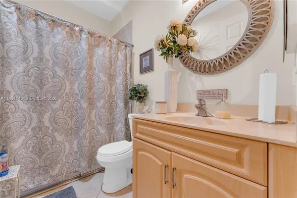 a bathroom with a sink a mirror and a toilet