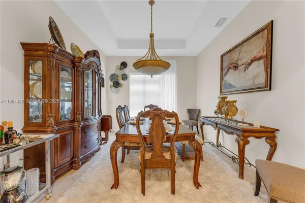 a dining room with furniture and window