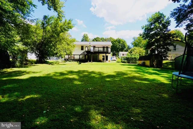 a big yard with swimming pool and green space