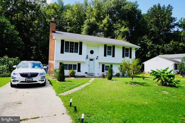 a front view of a house with a garden and yard