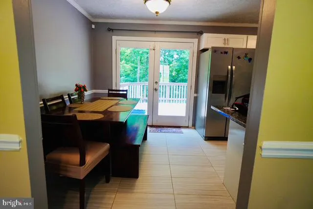 a dining room with furniture and a window