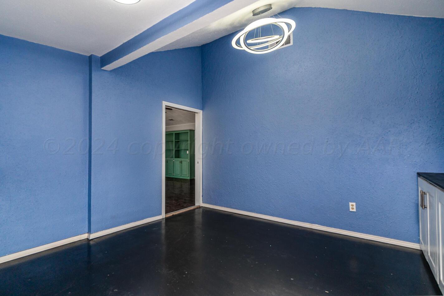 8012 Simpson Drive Amarillo, TX 79121 - Photo 14 of 28 an empty room with wooden floor