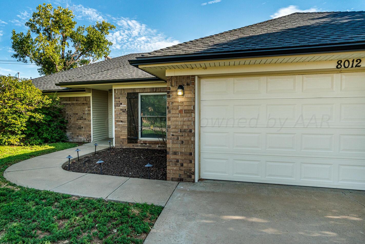 8012 Simpson Drive Amarillo, TX 79121 - Photo 2 of 28 a front view of a house with a yard