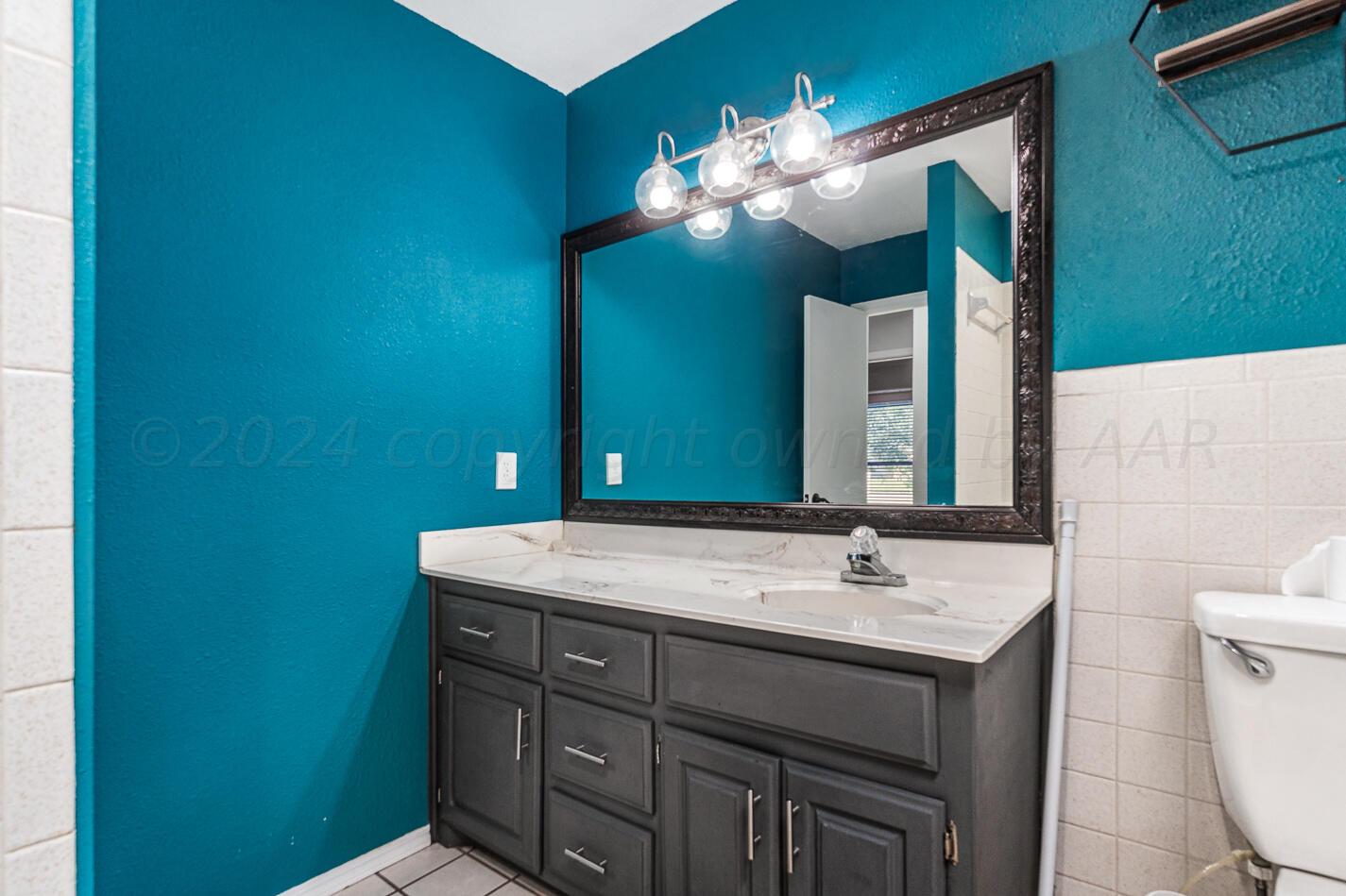 8012 Simpson Drive Amarillo, TX 79121 - Photo 22 of 28 a bathroom with a sink and a mirror