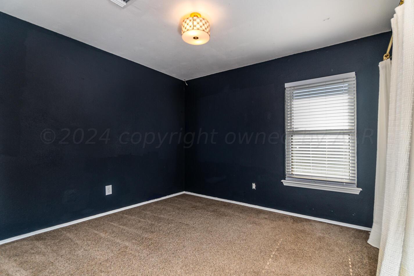8012 Simpson Drive Amarillo, TX 79121 - Photo 23 of 28 a view of an empty room with a window