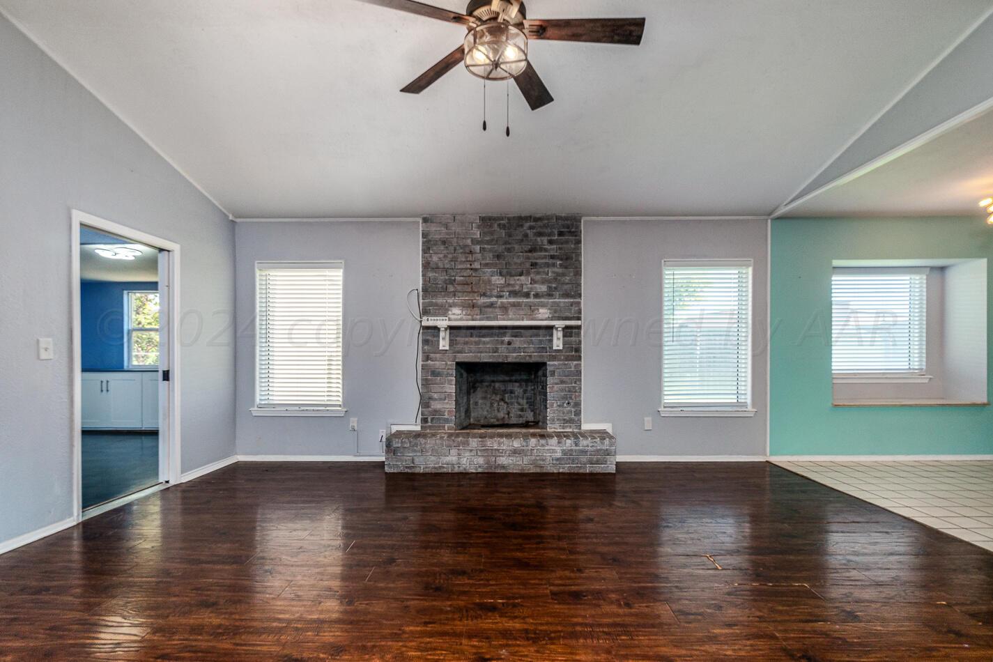 8012 Simpson Drive Amarillo, TX 79121 - Photo 5 of 28 a living room with fireplace and wooden floor