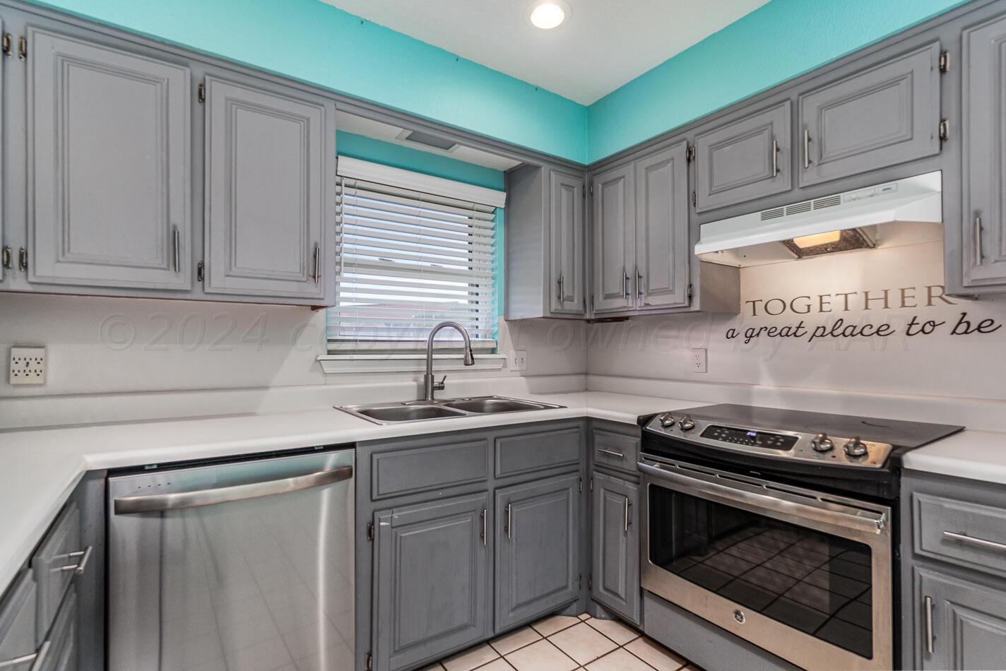 8012 Simpson Drive Amarillo, TX 79121 - Photo 10 of 28 a kitchen with a sink stove and cabinets