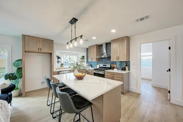 a kitchen with counter top space a sink and appliances