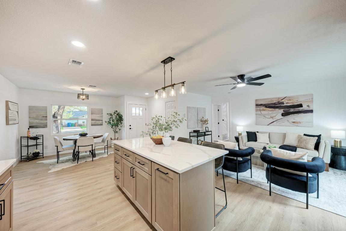 5106 Regency Drive Austin, TX 78724 - Photo 13 of 37 a large kitchen with a counter space a sink appliances and living room view