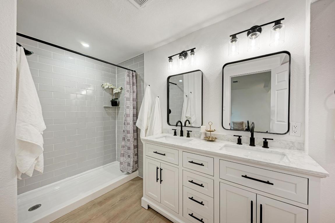 5106 Regency Drive Austin, TX 78724 - Photo 20 of 37 a bathroom with a double vanity sink mirror double and shower