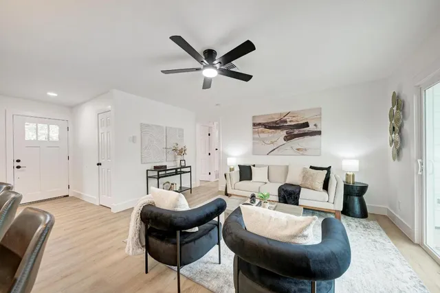 a living room with furniture and a chandelier