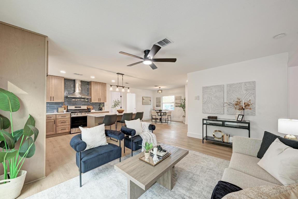 5106 Regency Drive Austin, TX 78724 - Photo 9 of 37 a living room with furniture kitchen view and a chandelier