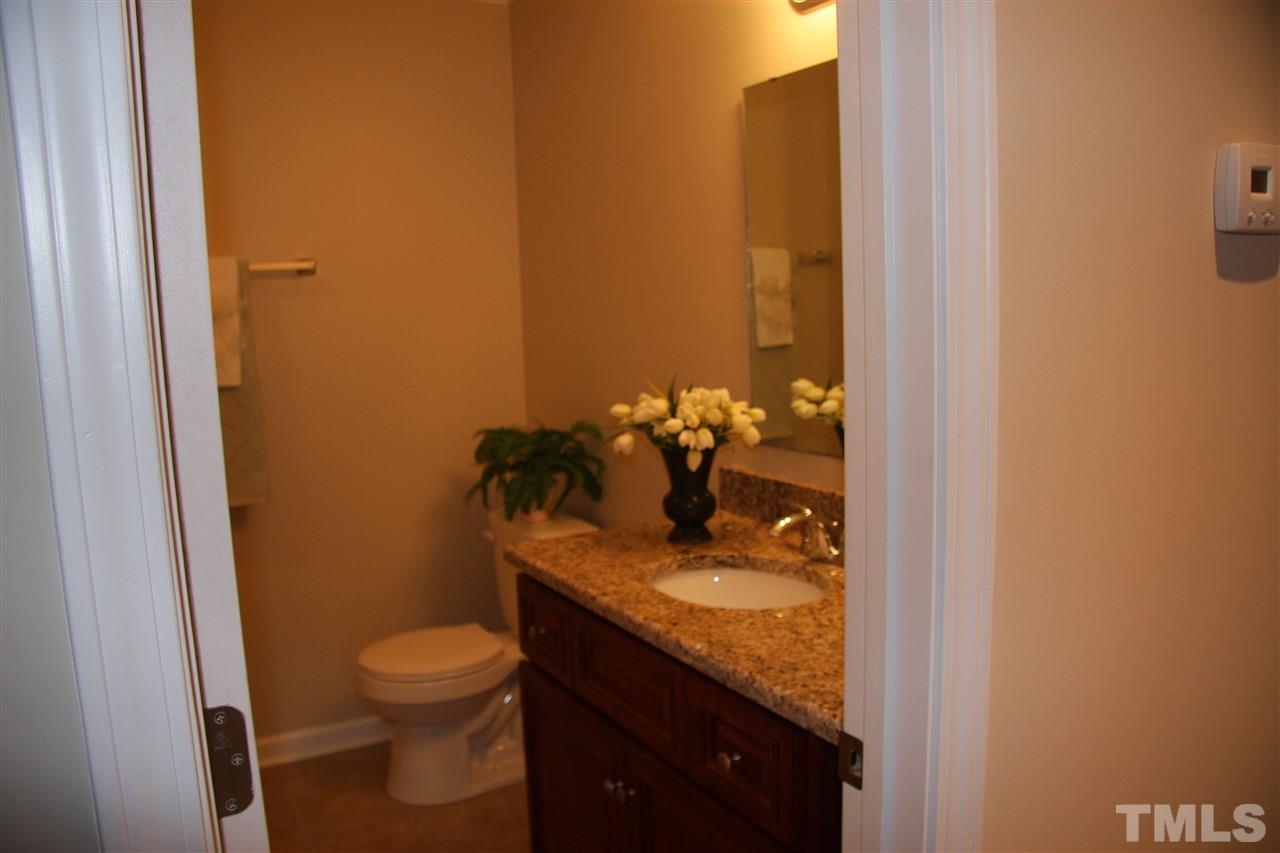 2104 Langdon Drive Raleigh, NC 27604 - Photo 14 of 21 a bathroom with a granite countertop sink and a toilet