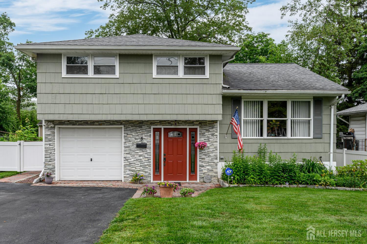 5 Locust Street Netcong, NJ 07857 - Photo 1 of 34 a front view of a house with a garden and garage