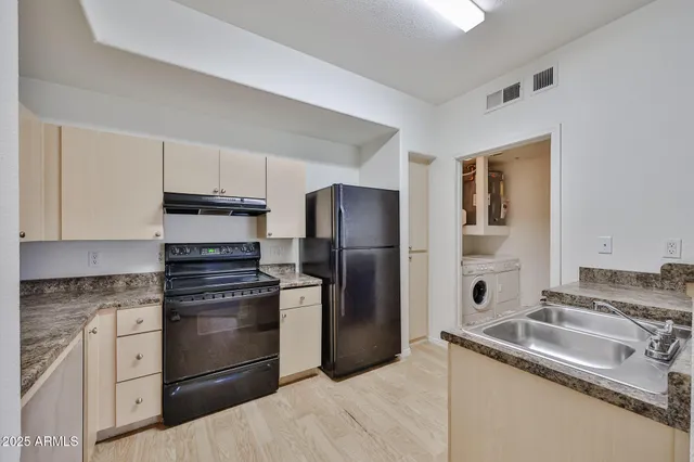 a kitchen with a sink stove and refrigerator