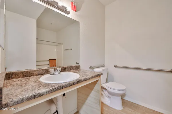 a bathroom with a toilet sink and mirror