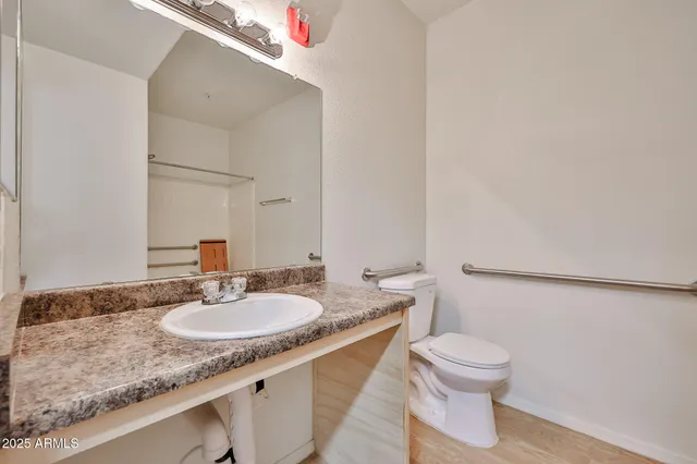 a bathroom with a toilet sink and mirror