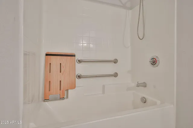 a bathroom with a bathtub and shower