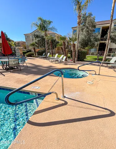 a view of a swimming pool with a lawn chairs